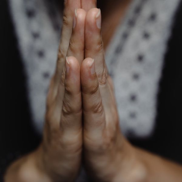 Close-up of hands in a meditative mudra position.